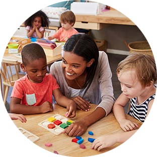 teacher smiles while students work